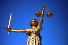 A photograph of a statue of Lady Justice, blindfolded and holding sword and scales.