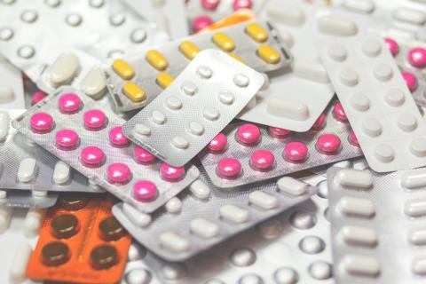 A pile of assorted sheets of tablets and capsules of medication.